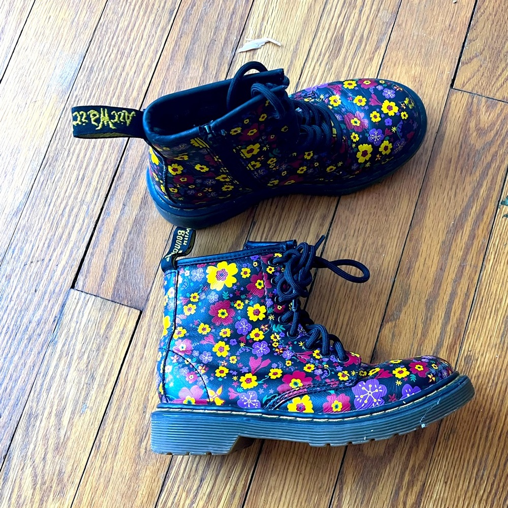 Dr. Martens flower boots on black leather base
